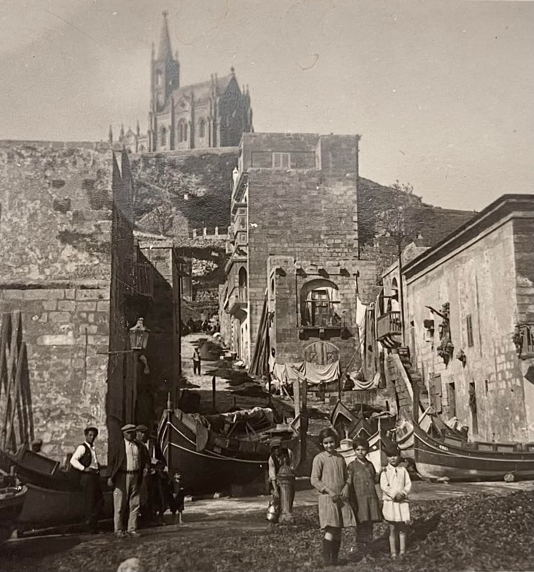 Mgarr Harbour with boats and locals