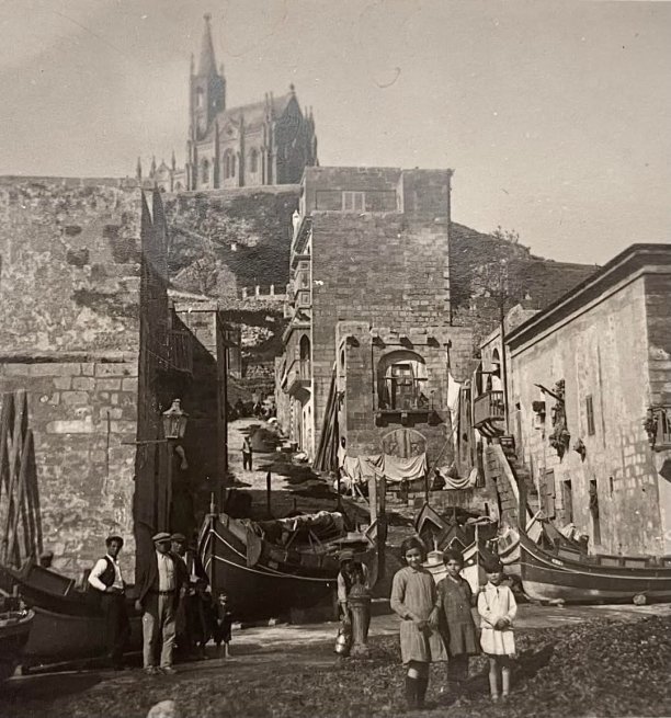 Mgarr Harbour with boats and locals