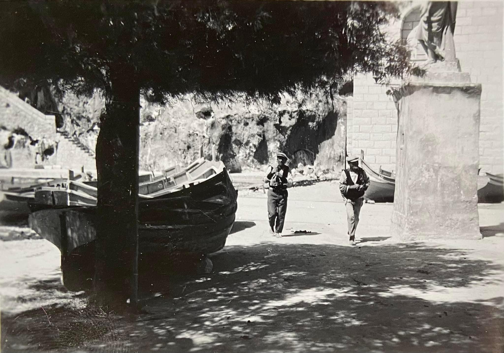 Fishermen and boats near Saint Andrew's statue, Xlendi