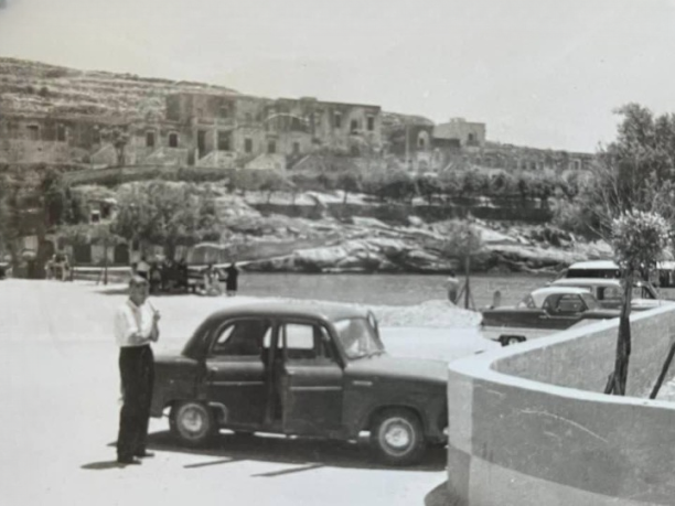 Vintage cars parked by Xlendi bay
