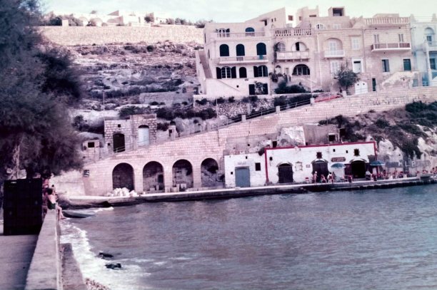 Xlendi waterfront with arched boathouses