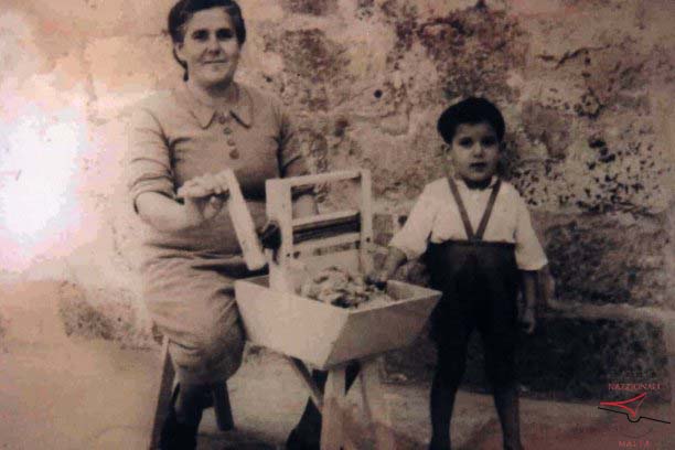 Woman separating cotton from its seed