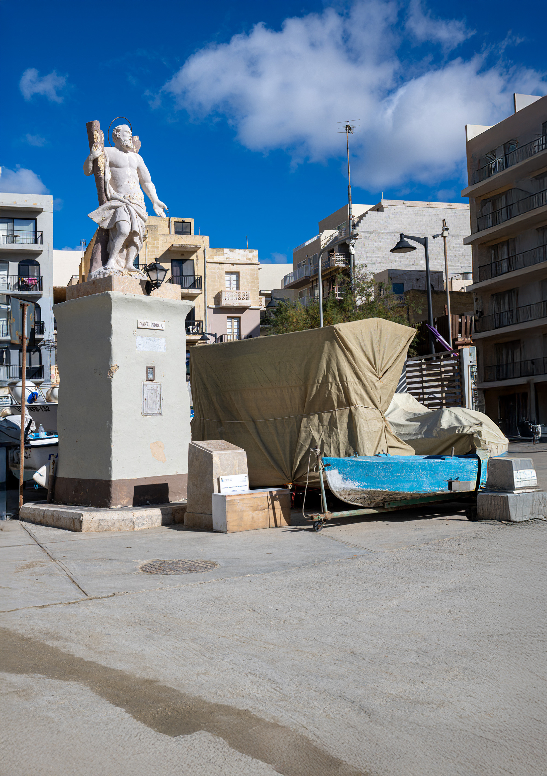 Statue of Saint Andrew and fishing boats in Xlendi