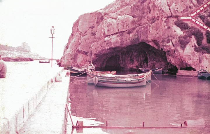 L-Għar Tad-Dgħajjes and moored boats in Xlendi